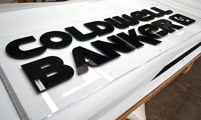 "Coldwell Banker" channel cut letters on clear acrylic backing