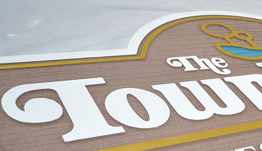 Closeup of "The Townhomes" sandblasted sign